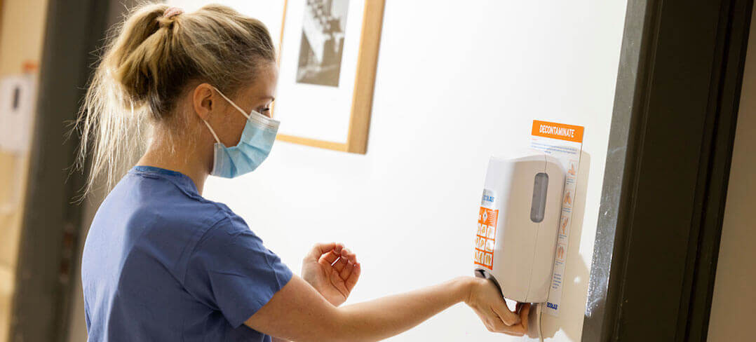 Nurse using hand sanitizer