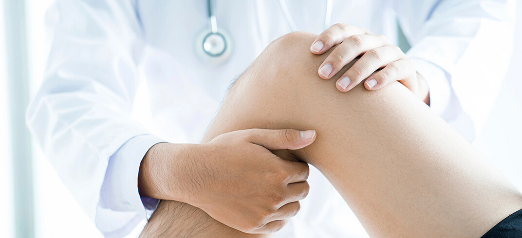 Doctor examining patient's knee