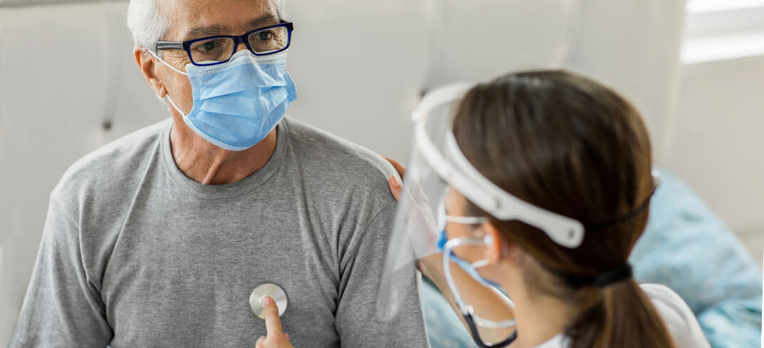 Provider listening to patient's heart with stethoscope