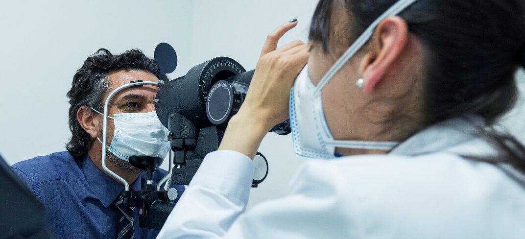 A doctor examining a patient's eye.