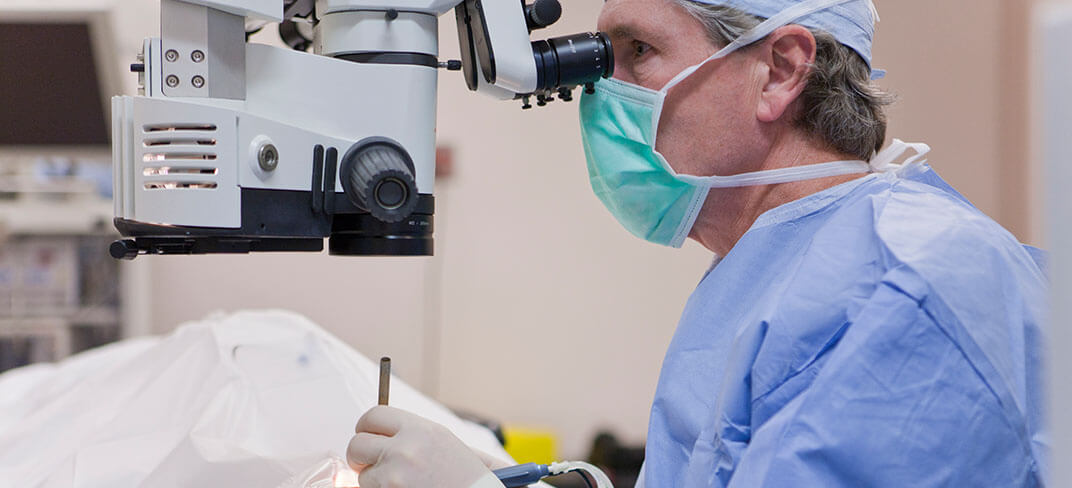 A doctor performing eye surgery.